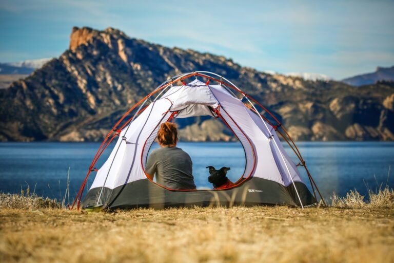 Orange tent set up at a campsite