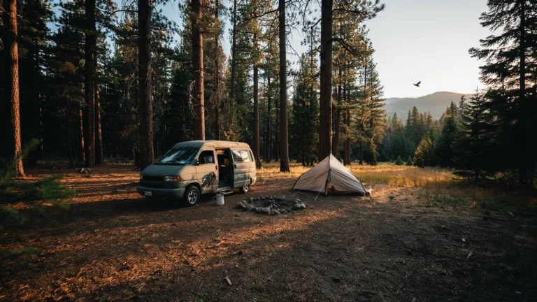 A campervan and tent at a remote dispersed campsite at sunset