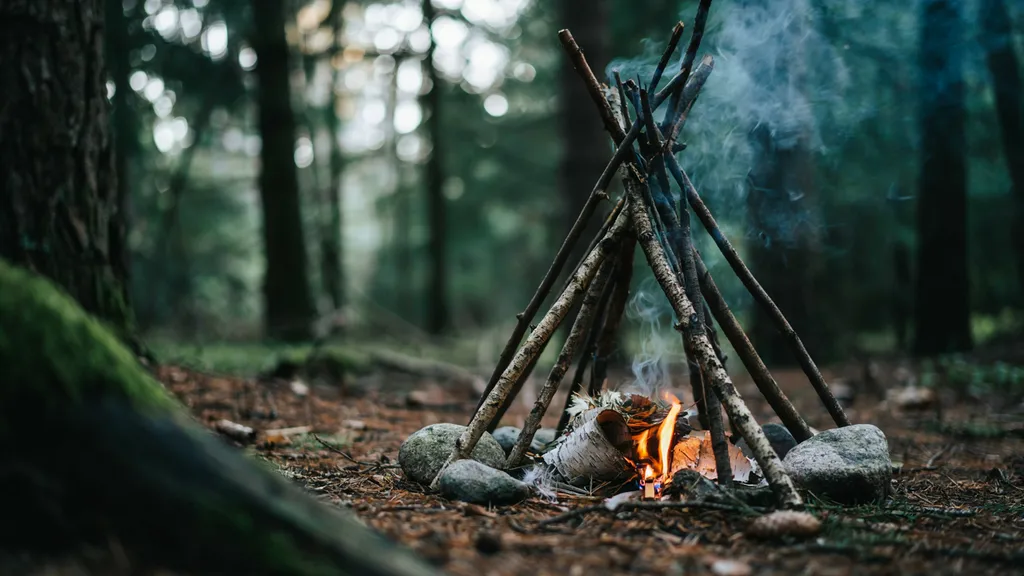 A teepee fire lay with dry tinder and kindling ready to light