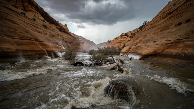 Flash flood surging through a narrow desert slot canyon